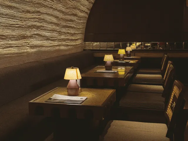 Restaurant dining room lit by table lamps
